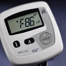 A close-up photograph of a blood glucose meter displaying a digital reading, showcasing the science and technology behind blood sugar testing.